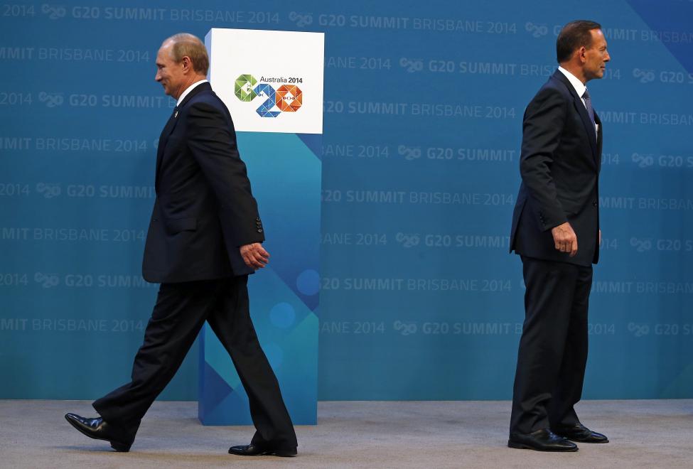 Australian Prime Minister Tony Abbott stands near Russian President Vladimir Putin after officially welcoming him to the G20 leaders summit in Brisbane