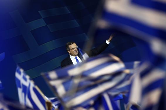 Greek Prime Minister and leader of the conservative New Democracy party Samaras waves to supporters during a campaign rally in Athens